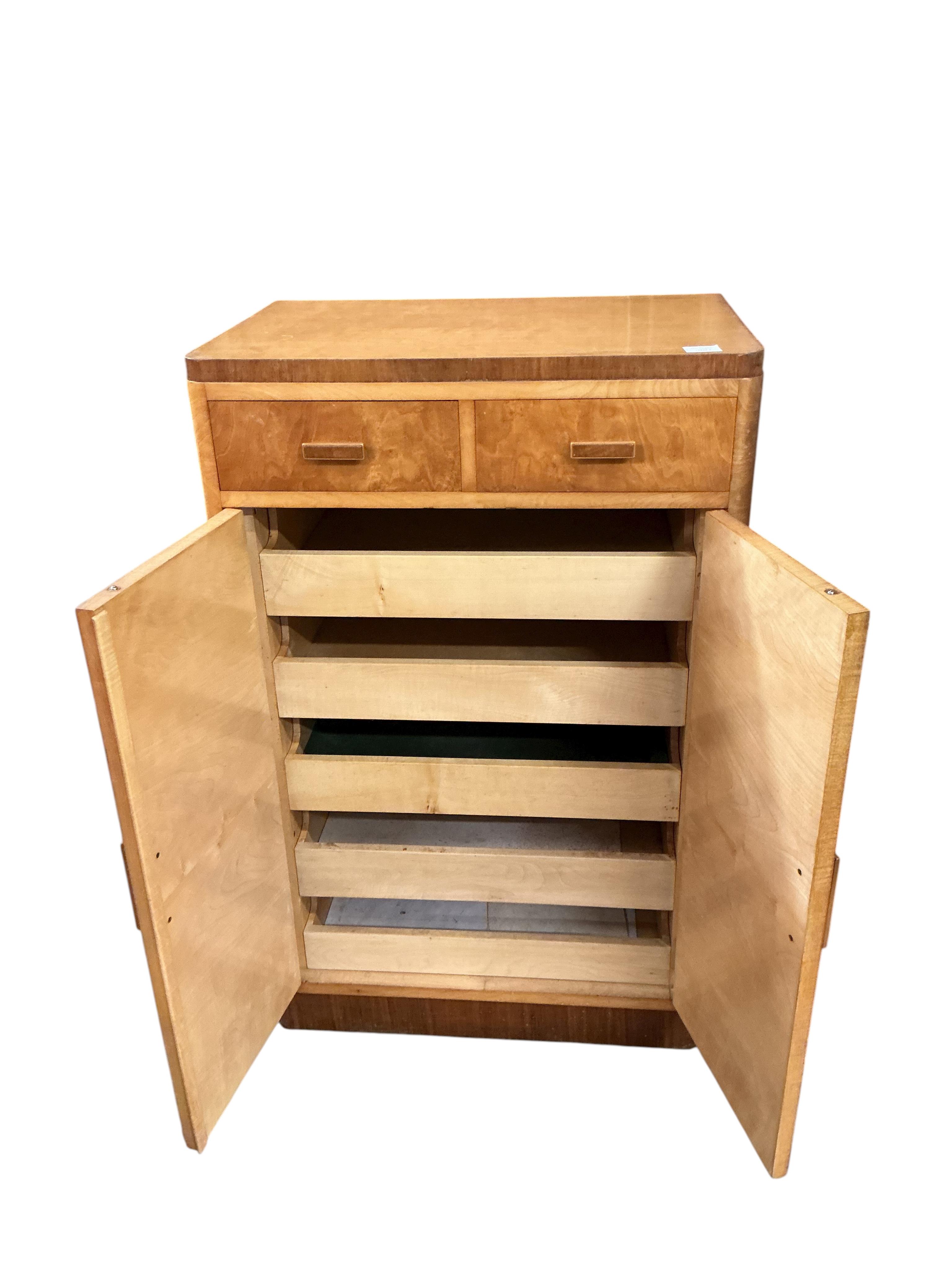 An early 20th century maple two drawer press cupboard, width 68cm, depth 45cm, height 107cm